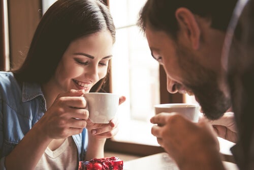 A man and a woman drinking coffee.