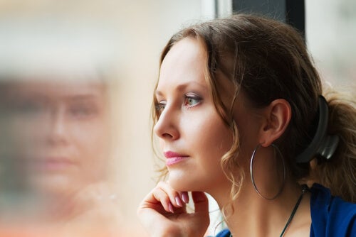 A woman sitting by a window.