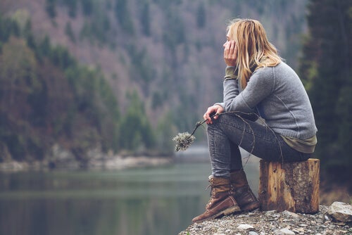 A woman thinking by the river.