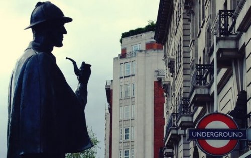 Sherlock Holmes looking at a building.