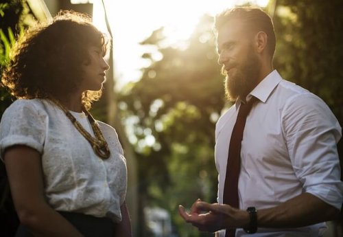 A man talking to a woman.