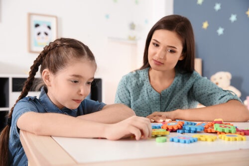A teacher watching a girl play.