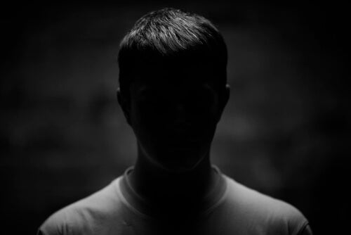 A man in a dark background.