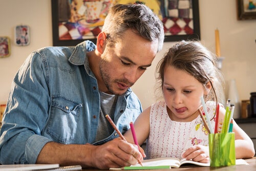 A man helping his daughter with her homework which can be very beneficial for children's education.