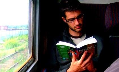 A man reading on a train.