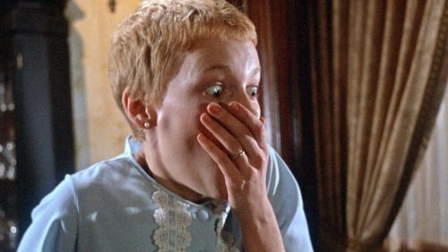 Rosemary covering her mouth with her hand.
