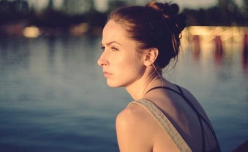 A serious-looking woman looking away.