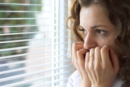 A woman worried at the window.