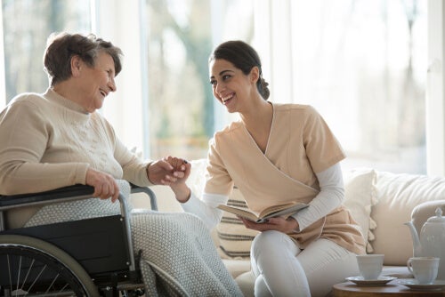 A nurse holding a patient's hand.