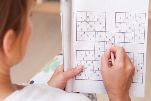 A woman doing a Sudoku.