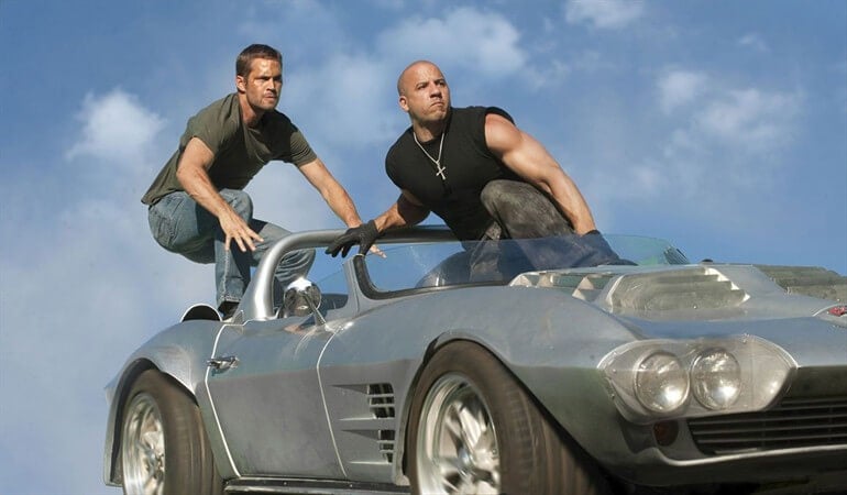 Two of the Fast and Furious characters on a car.