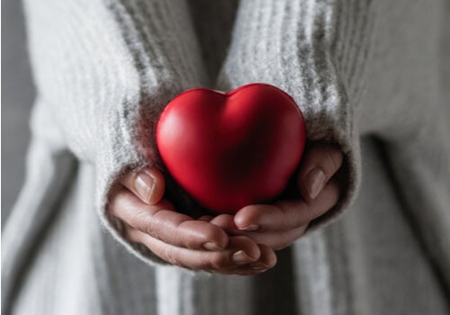A woman holding a heart.