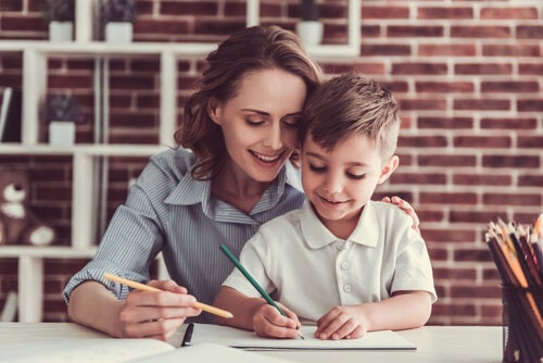 A woman helping a child write.