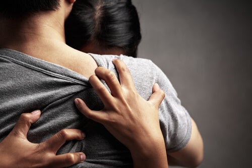 A woman hugging a man tightly.