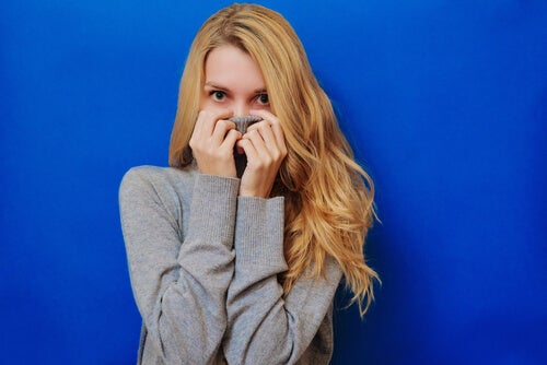 A woman hiding her mouth in embarrassment.
