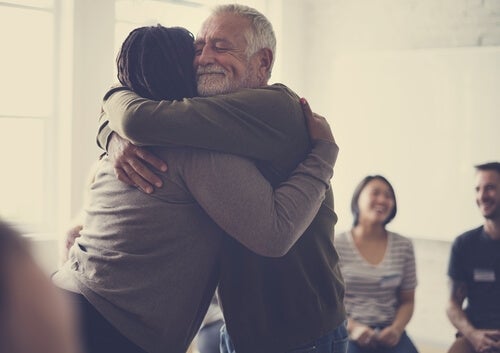 A man and a woman hugging each other.