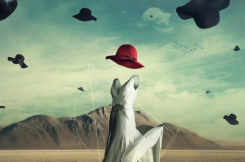 An abstract image of an empty dress and red hat.