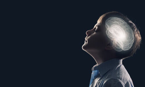 A child with his eyes closed and an image of his brain.