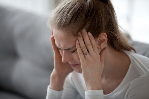 A woman in pain from a headache.