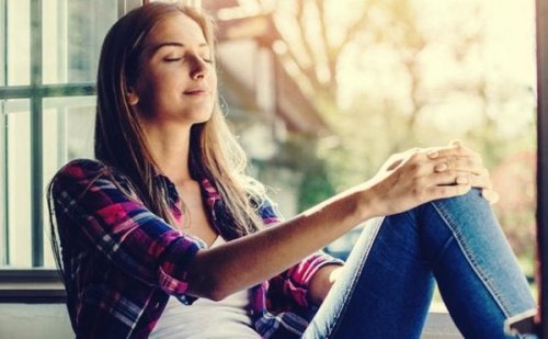 A woman leaning back and looking content with her eyes closed.