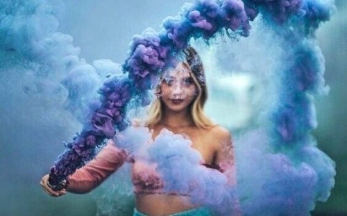A woman with purple and blue smoke.