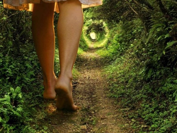 A woman walking down a path with spiral.