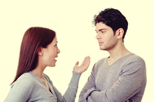 A woman talking while a man stares at her.