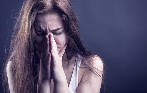 A woman who's crying possibly because she's a victim of abuse.