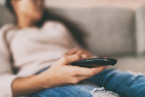 A person sleeping in front of the TV.