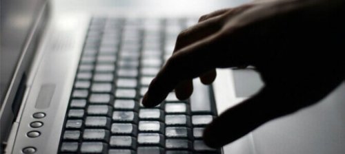 A person typing on a keyboard.