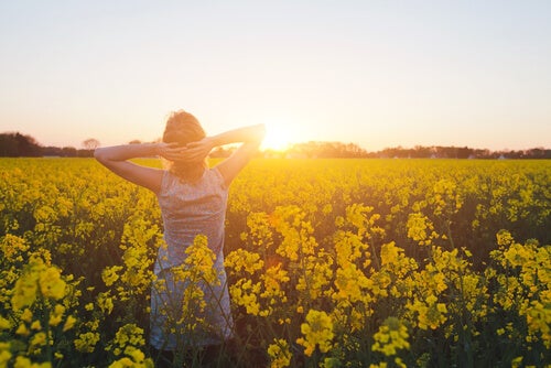 A woman in a canola field.