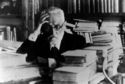Miguel Unamuno seated at his desk.