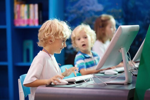 Three children in a computer lab.