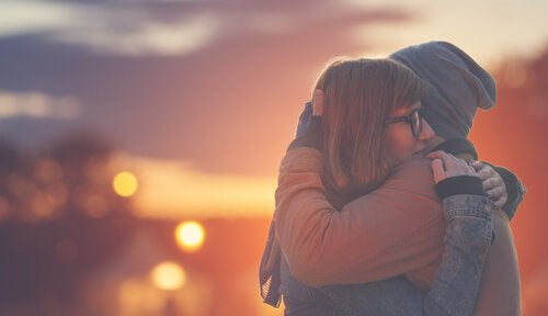 Two people hugging.