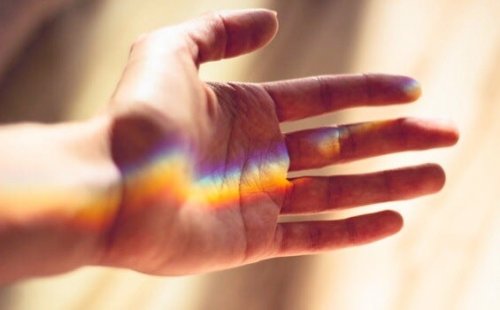 A rainbow reflected on someone's palm.