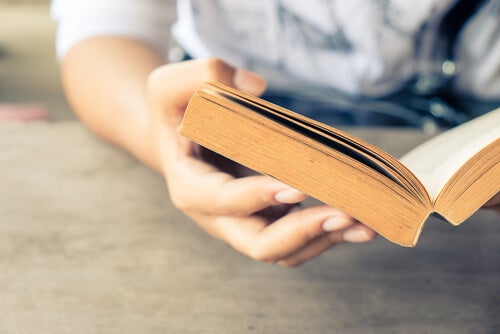 A person holding a book open.