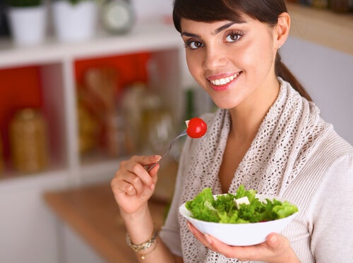 A woman fighting calcium and magnesium definciency by eating salad.