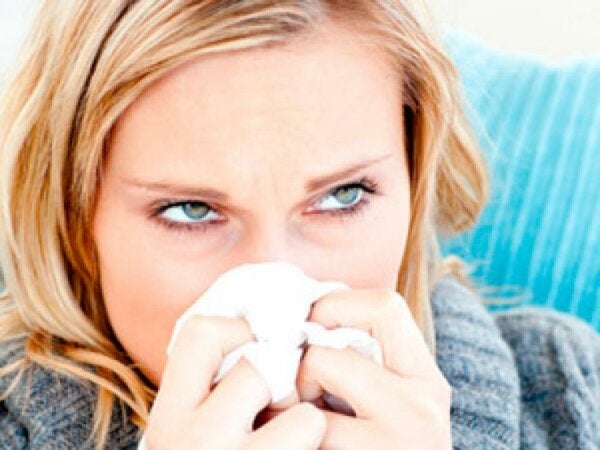 A woman sneezing.