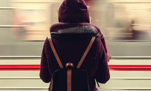 A woman in front of a moving train.