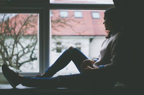 A woman sitting at a window.