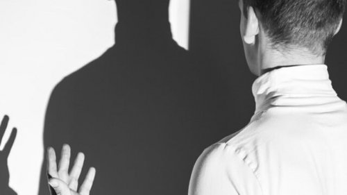 A person talking to their shadow.