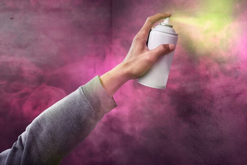 A person spraying paint.