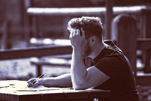 A man writing, representing gifted adults.