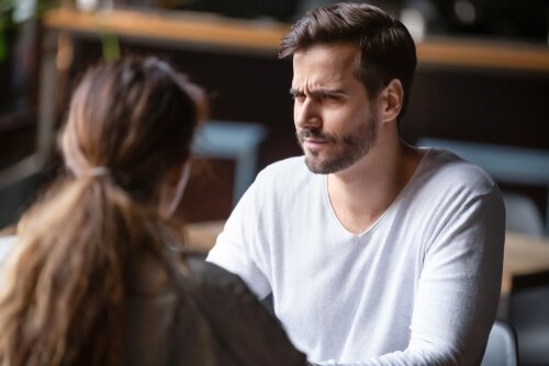A man hearing something he doesn't like.