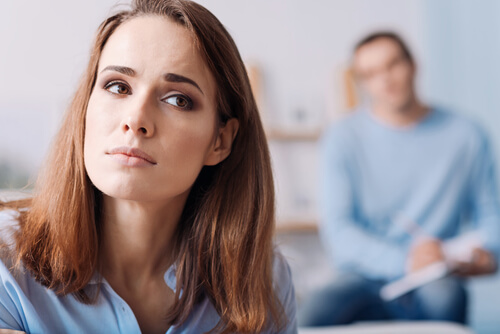 A woman ignoring a person behind her.