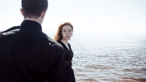 Two people by the sea.
