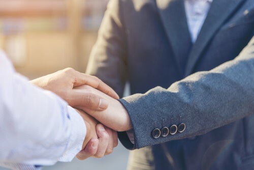 Two people shaking hands.