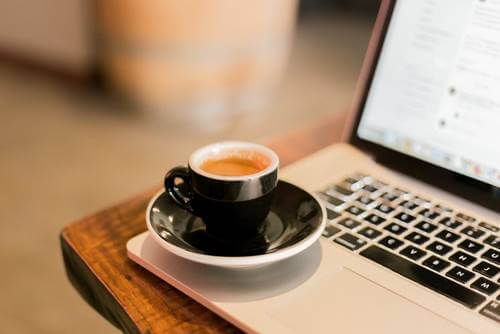 A cup of coffee on a laptop.