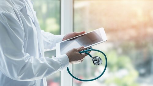 A doctor with a tablet.