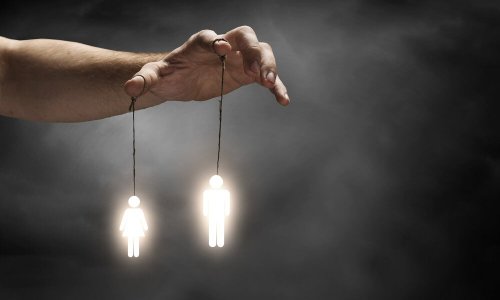 A hand manipulating two figures, representing the different types of authority.